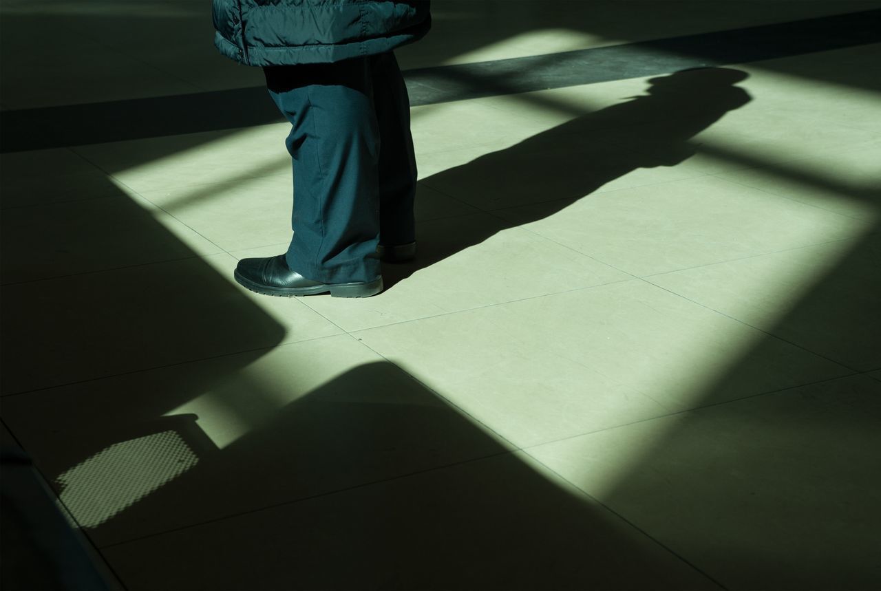 LOW SECTION OF PERSON ON FLOOR AT HOME