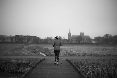 Rear view of woman running in park