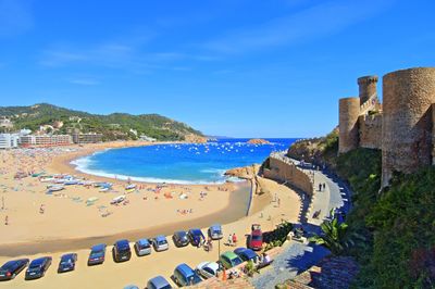 High angle view of cars parked at beach against clear blue sky in tossa de mar