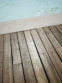 High angle view of boardwalk by swimming pool