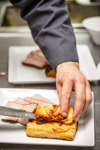 Cropped image of man preparing food on table