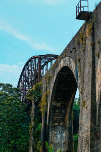 Low angle view of arch bridge against sky