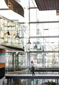 Full length of businessman standing at office atrium