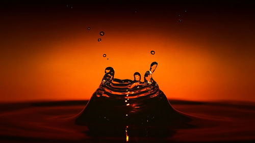 Close-up of water drops on orange surface