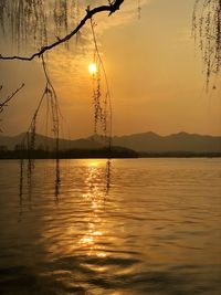 Scenic view of lake against sky during sunset