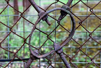 Old rusty metal against chainlink fence