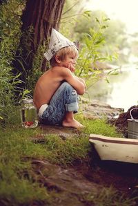 Boy sitting in yard