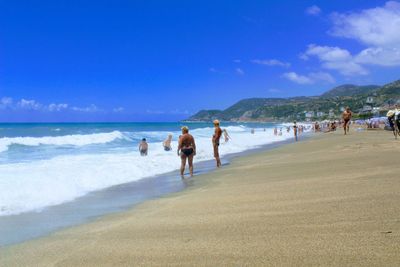 People on beach against sky