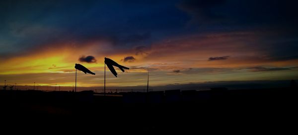 Low angle view of silhouette trees against sky at sunset