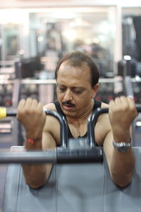 Mature man exercising at gym