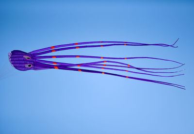 Close-up of octopus shaped kite against clear blue sky