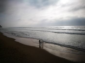 Scenic view of beach against sky during sunset