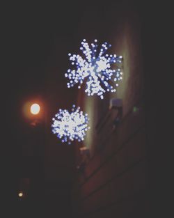 Low angle view of illuminated lights at night