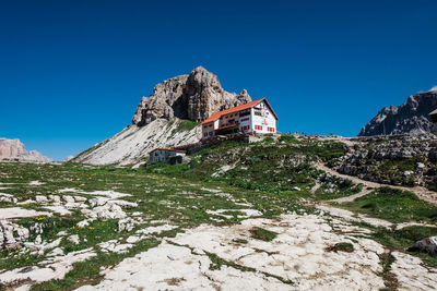 Low angle view of buildings against clear blue sky