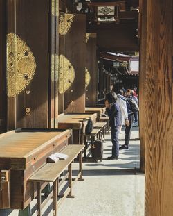 Rear view of people walking on table