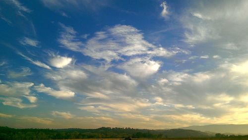 Scenic view of landscape against cloudy sky