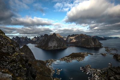 Scenic view of sea and mountains against sky