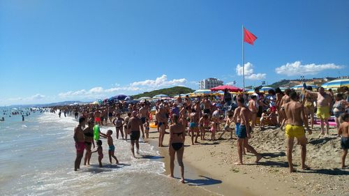 People on beach against sky