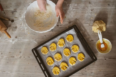 Cropped image of hand making cookies on table