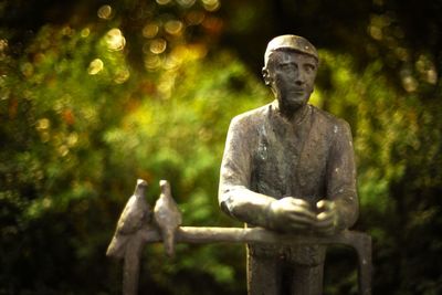 Low angle view of statue against trees