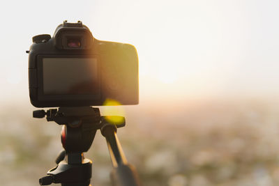 Close-up of camera against sky