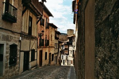 Narrow alley amidst buildings in city