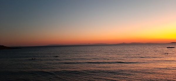 Scenic view of sea against orange sky