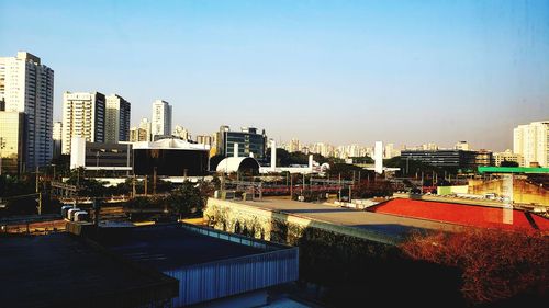 Buildings in city against clear sky