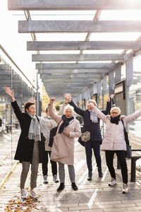 Group of senior women waving at station