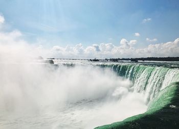 Panoramic view of waterfall against sky