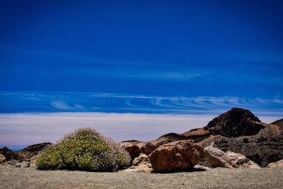 Rock formations on landscape against blue sky