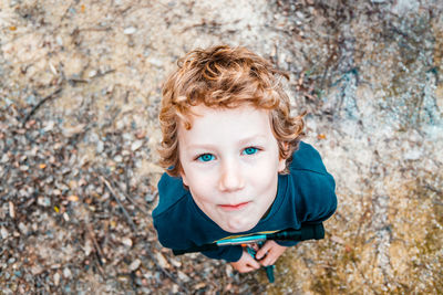 High angle view of boy standing outdoors