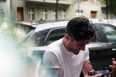 Side view of man looking at city