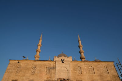 Low angle view of building against clear blue sky