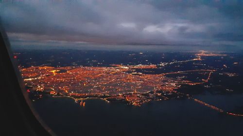 High angle view of illuminated city buildings against sky