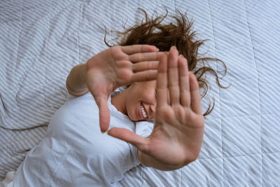 Portrait of woman lying on bed