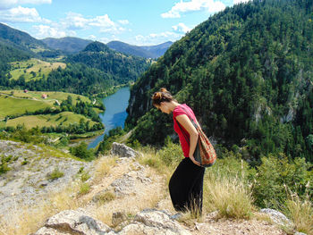 Woman on landscape against mountains