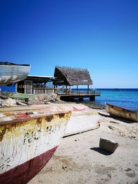 Built structure on beach against clear blue sky