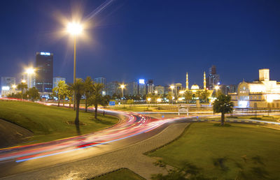 Light trails on road along buildings at night