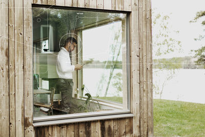 Man using smart phone in weekend cottage