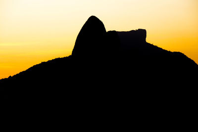 Silhouette of rock formations against sky