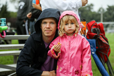 Portrait of father and daughter outside at sports activity