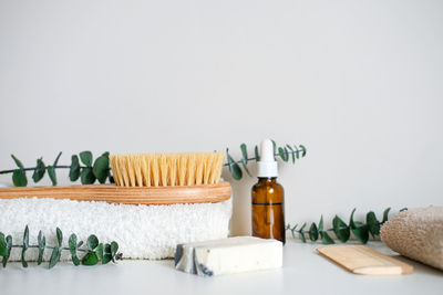 Massage wooden body brush on the background of spa items. homemade body care.