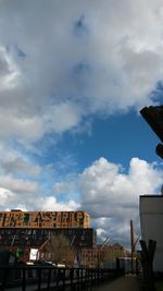 Low angle view of building against cloudy sky