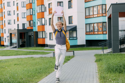 A happy student runs to school, hurries to classes, rejoices in the new academic year.