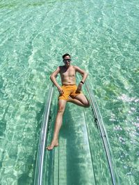 High angle view of man swimming in sea