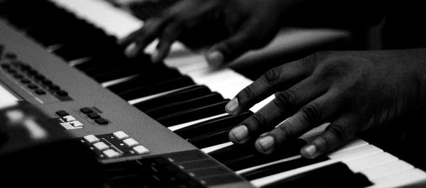 Human hand playing piano