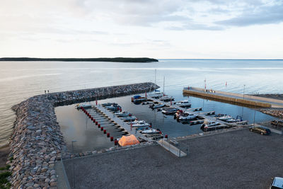 High angle view of sea against sky. small harbour and pier with little boats.