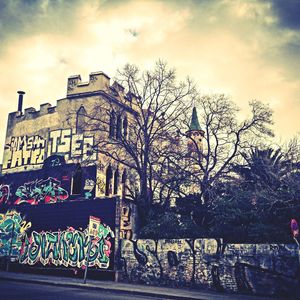 Graffiti on wall against sky