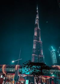 Low angle view of illuminated buildings against sky at night